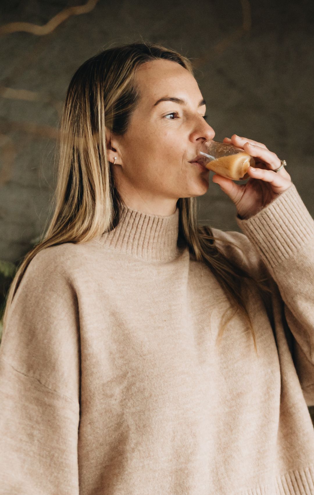A woman drinking from a cup