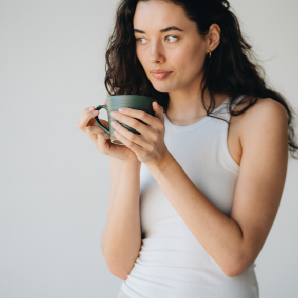 Woman holding a cup with both hands